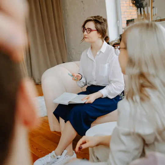 A coach in conversation with a business owner